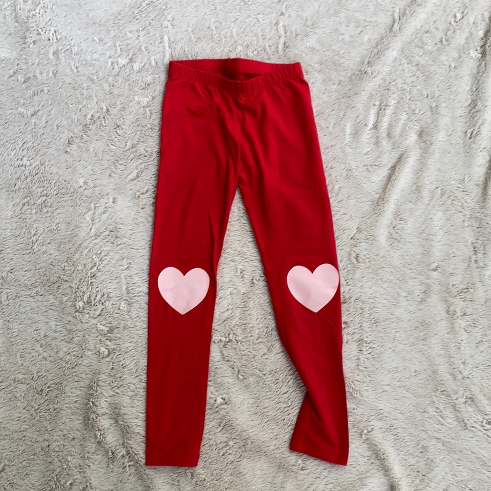 red leggings with hearts on the knees